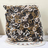 A pile of black and beige nylon elastic hair cords for kids headbands.