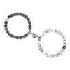 A pair of natural stone heart couple bracelets, one dark gray and one silver, displayed against a white background.