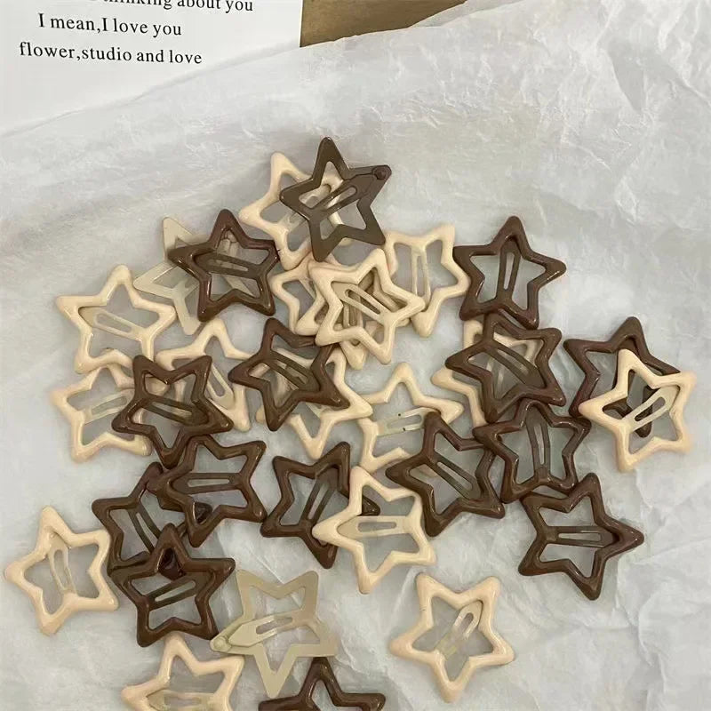 A collection of Y2K sweet star barrettes hair clips in brown and beige tones on white paper.