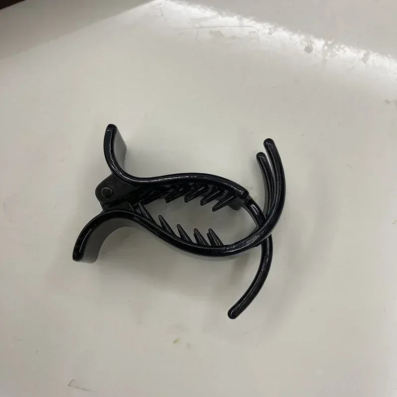 Black acrylic hair claw designed for ponytail styling