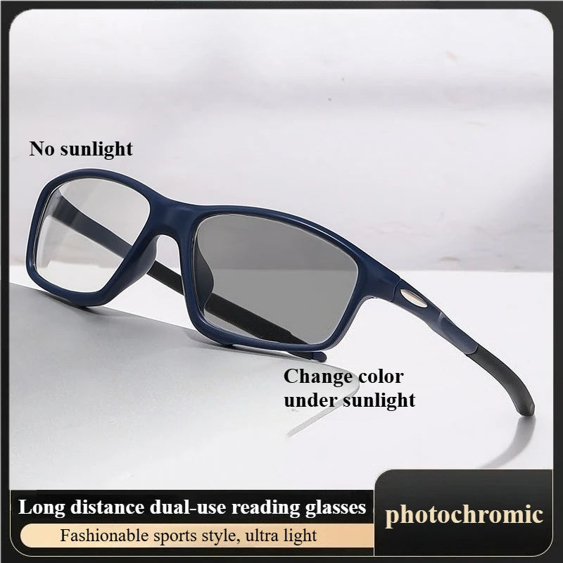 A pair of dark blue photochromic reading glasses resting on a white surface.