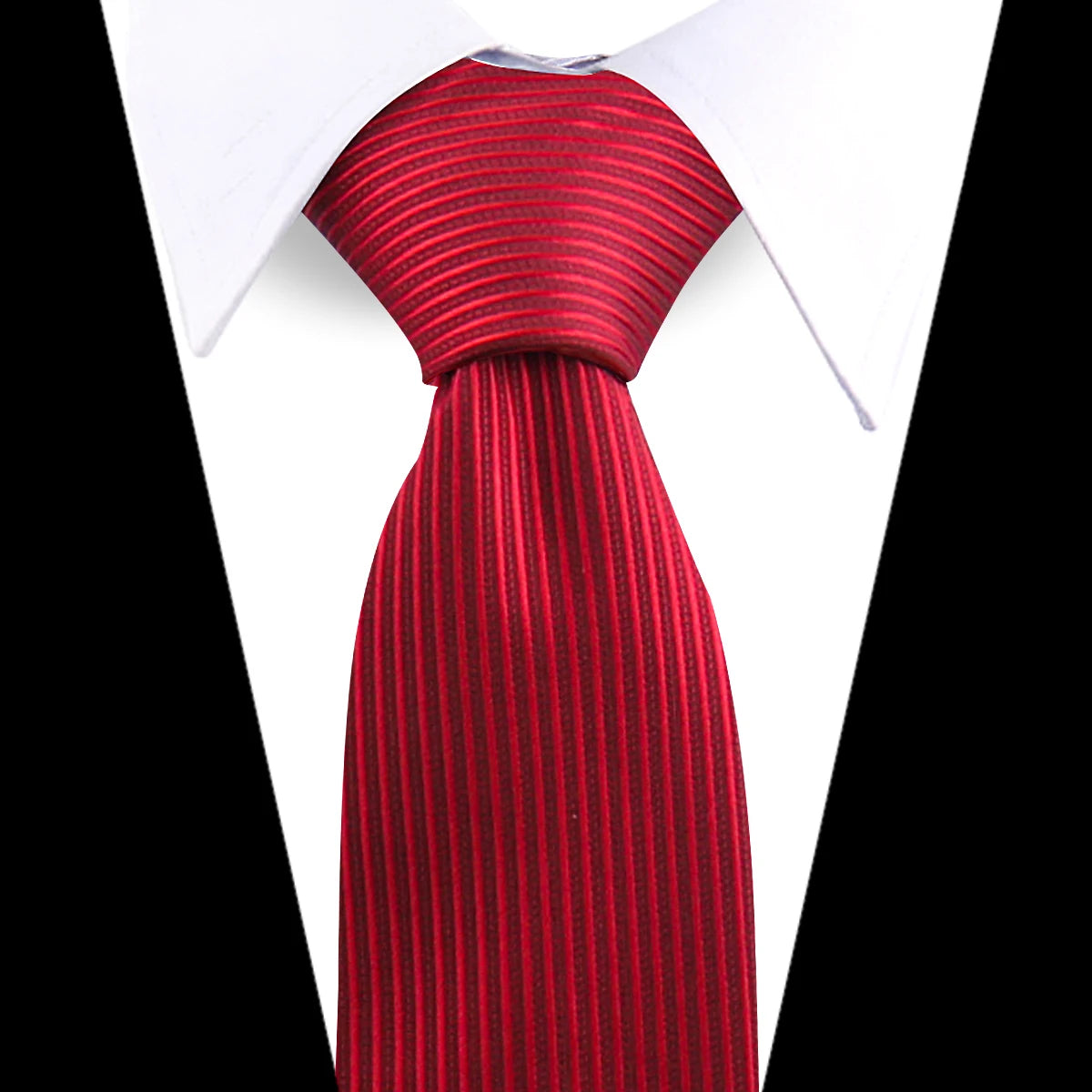 A close-up of a red striped silk necktie against a white shirt collar.