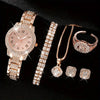 Ein Set eleganter Quarz-Kristall-Armbanduhren und goldfarbener Schmuck auf schwarzem Hintergrund.