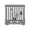 An enamel pin featuring a cartoon goose inside a striped cage with the text got too silly.