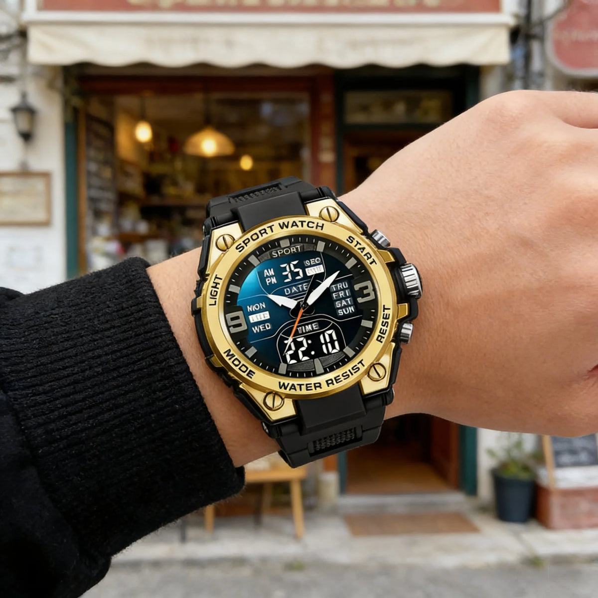 A close-up shot of a black multi-function digital wristwatch worn on a person's wrist in an outdoor setting.