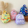 A collection of colorful kids backpacks featuring dinosaur and unicorn patterns.