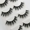 A collection of black handmade mink strip eyelashes displayed on a white plastic tray.