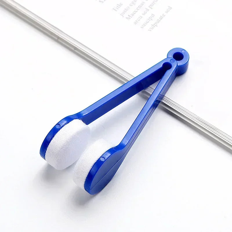 Blue portable tool with white cleaning pads for eyeglasses