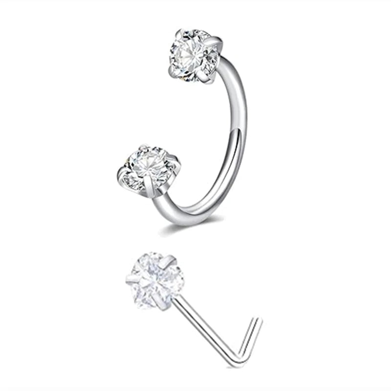 A set of silver horseshoe nose rings, including a hoop and a stud, with clear diamond-cut stones.
