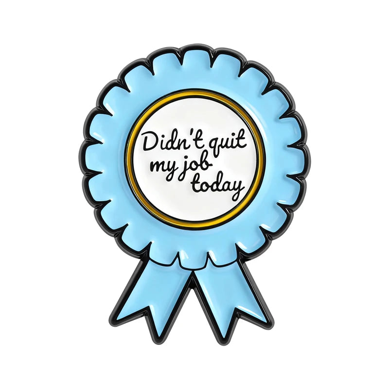 Light blue enamel pin shaped like a ribbon with the text Didn't quit my job today