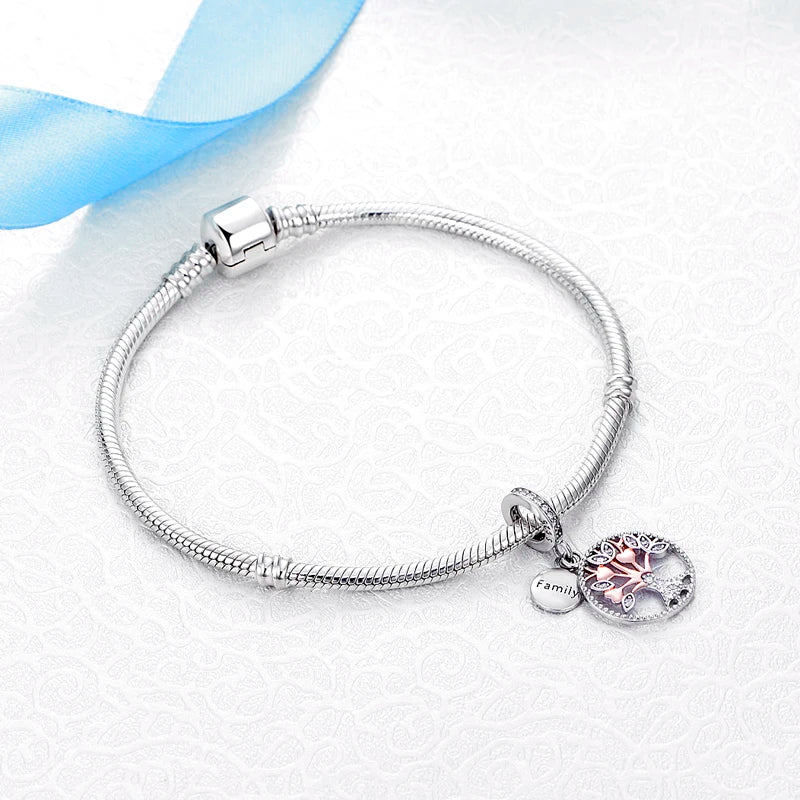 A sterling silver bracelet with a family tree charm and a blue ribbon on a white background.