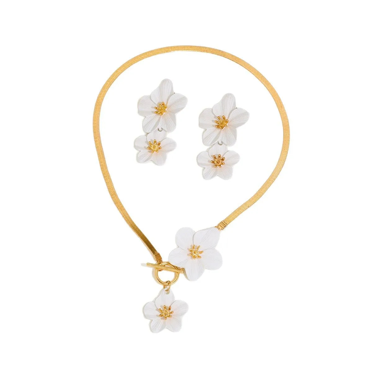 A gold-colored necklace and earring set featuring white floral pendants.