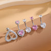 A set of five gold stainless steel dangled belly button rings featuring pink and clear gemstone designs.