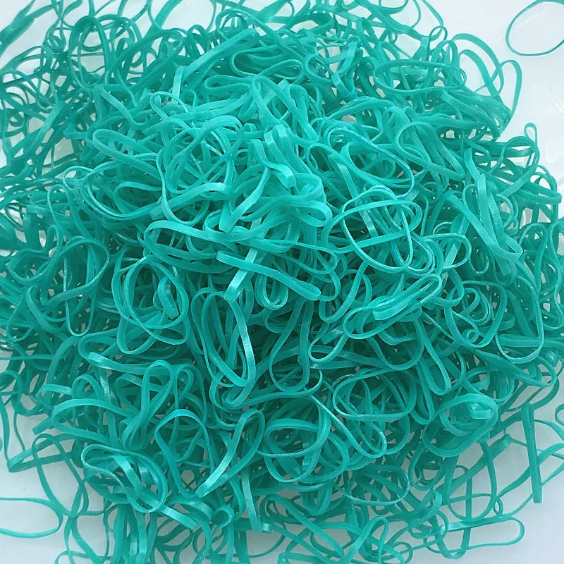 A pile of colorful disposable hair scrunchies in various shades of teal and green.