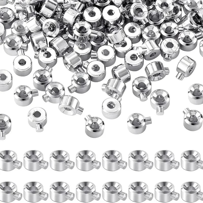 A collection of silver jewelry findings stoppers and spacers for connectors.