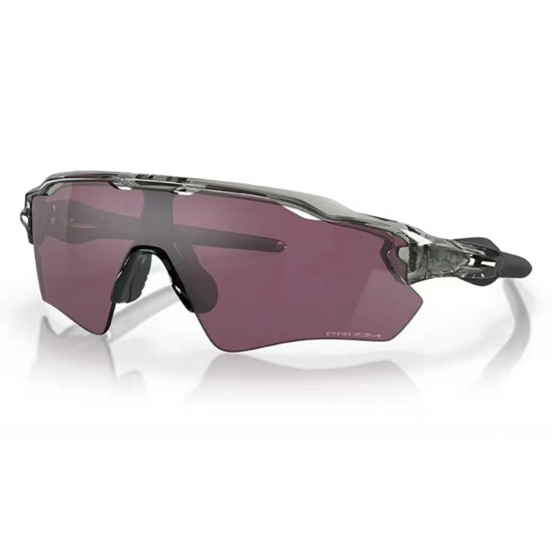 Purple tinted cycling sunglasses with a clear frame resting on a white surface.