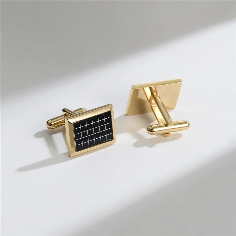 A pair of elegant gold-toned cufflinks featuring a square design with a black grid pattern.