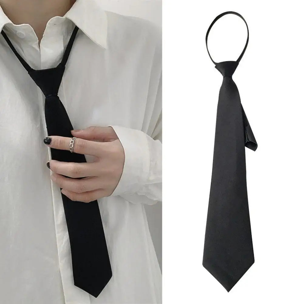 A black clip-on tie is shown against a white shirt, displayed both on a person and separately.