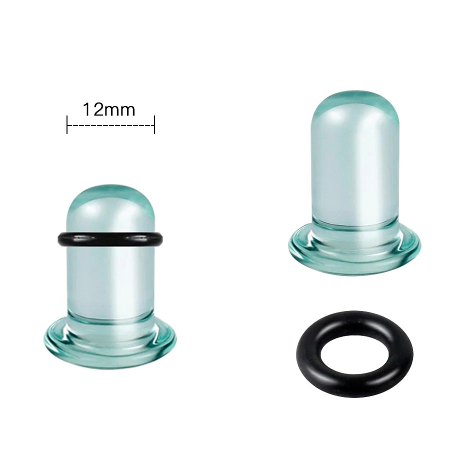 A clear glass ear stretching plug with a black ring and a measurement scale.