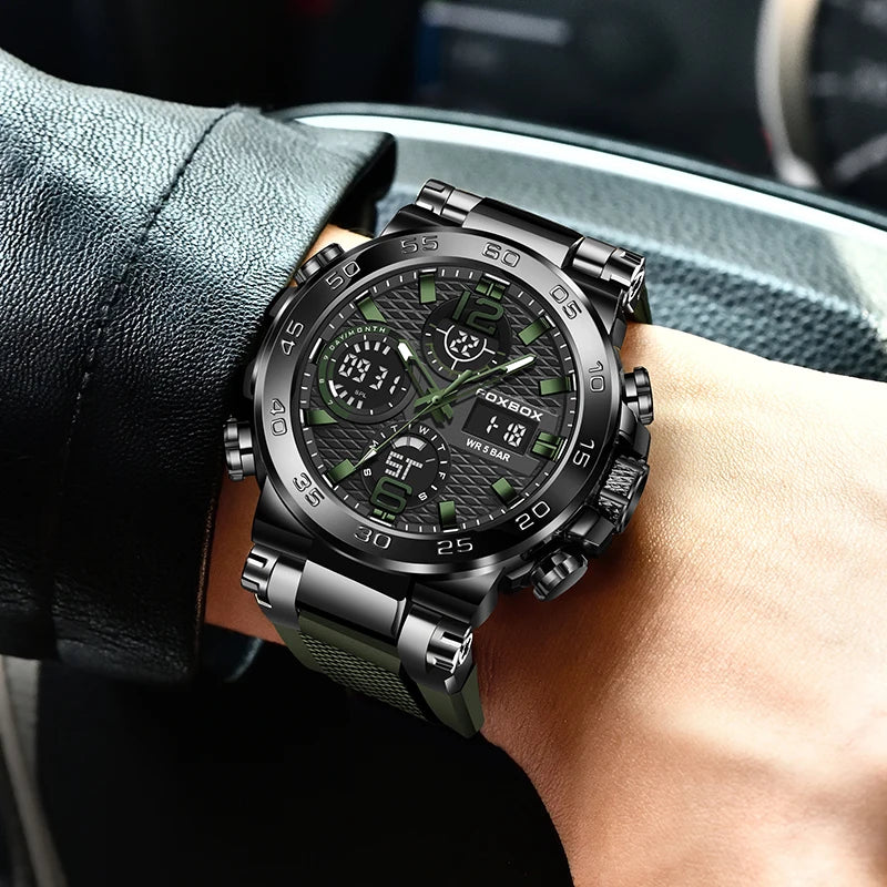 A close-up of a black luxury men's chronograph dive watch worn on a wrist, resting near a dark fabric surface.