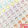A collection of 10 pink and white resin heart-shaped nail art charms on a white background.