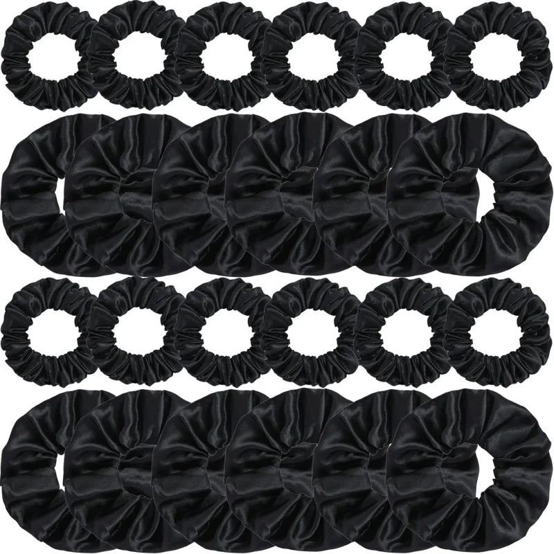A collection of black satin elastic hair ties for ponytail holders.