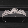 A sparkling crystal rhinestone bridal tiara headpiece displayed on a dark surface.