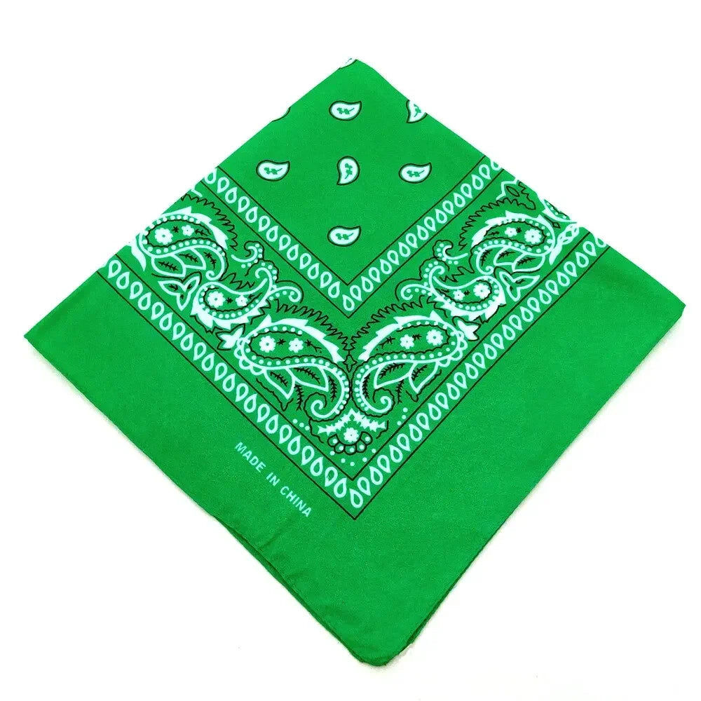 A bright green bandana featuring white paisley and geometric patterns, made in China.