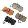Three leather pouches for portable eyewear storage in tan, olive green, and black.