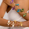 Elegant floral open cuff armlet jewelry worn on a wrist.