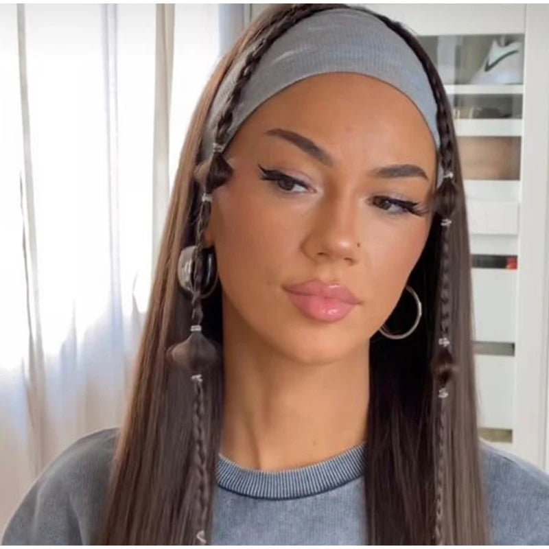 A woman modeling a grey knitted sports headband worn as a braid accessory on her long dark hair.