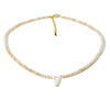 A delicate mother of pearl initial necklace featuring crystal accents on a gold-toned chain.