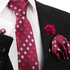 Maroon polka dot tie and matching silk scarf displayed against a black suit jacket and white shirt.
