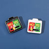 Two enamel brooch pins showing 'NO YES' and 'YES' mood expressions on a blue background.