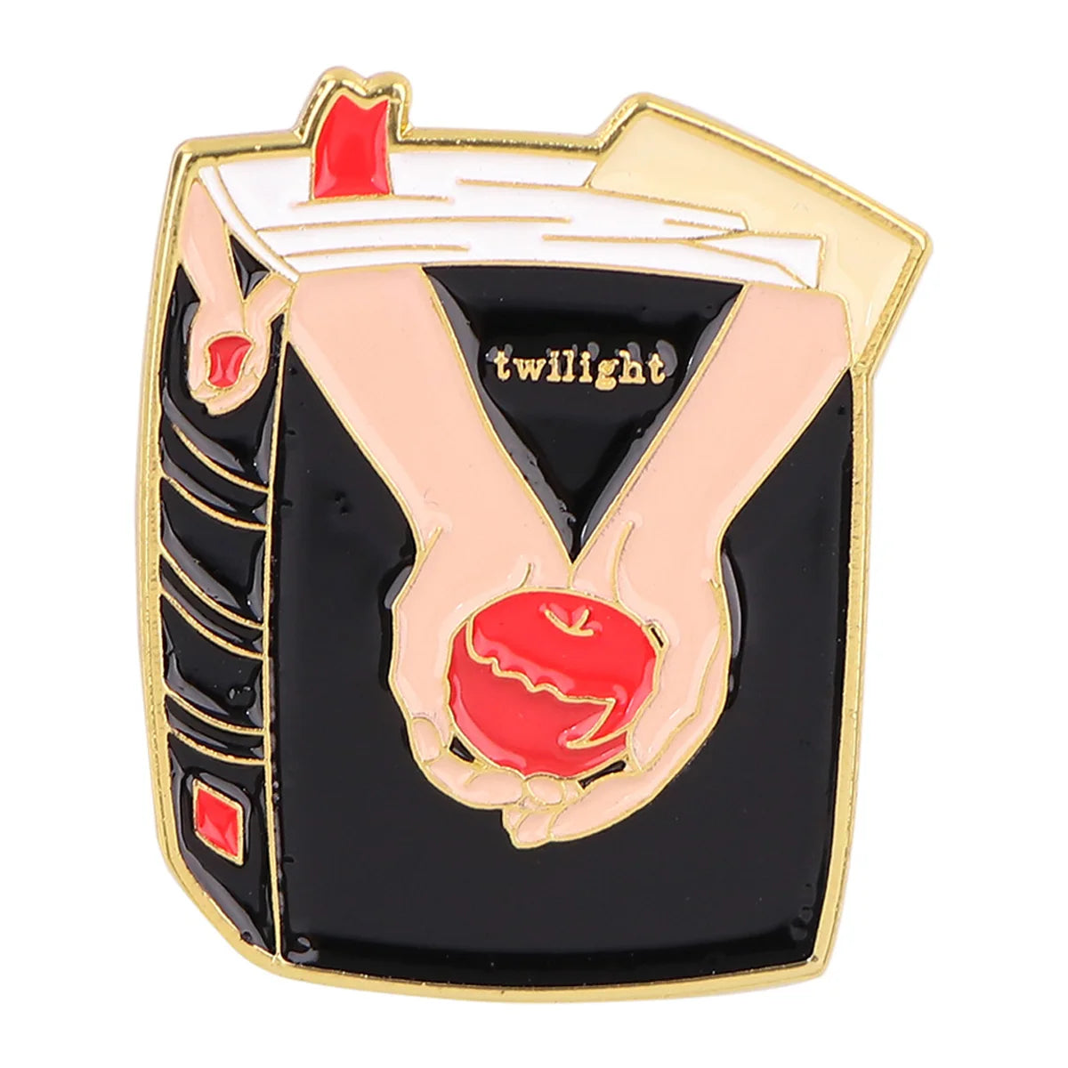 Broche émail à bordure dorée représentant une main tenant une pomme rouge et le mot crépuscule.