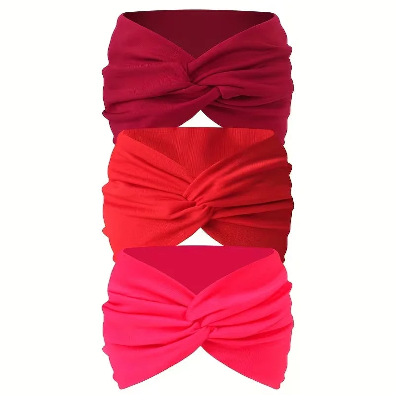 Ein Set aus drei leuchtend roten und rosa rutschfesten, breiten Haargummis, gebunden in einer Schleife.