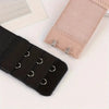 A pair of beige adjustable bra extender straps is shown next to a black strap on a white background.
