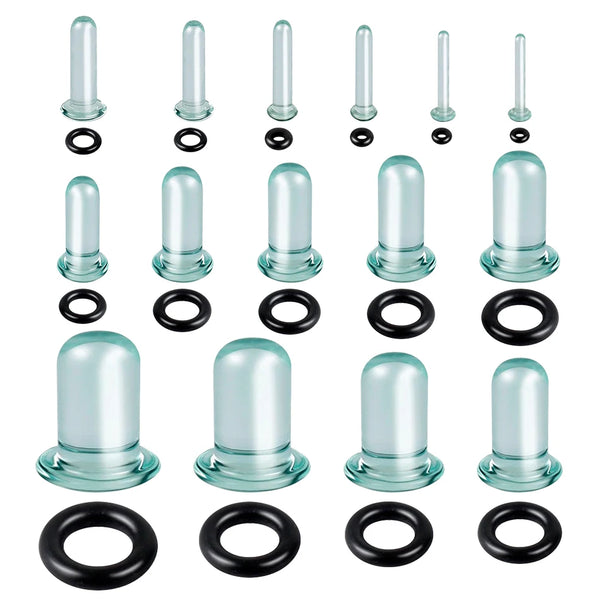 A set of glass ear stretching kits including various sized plugs and rings for ear tunnels
