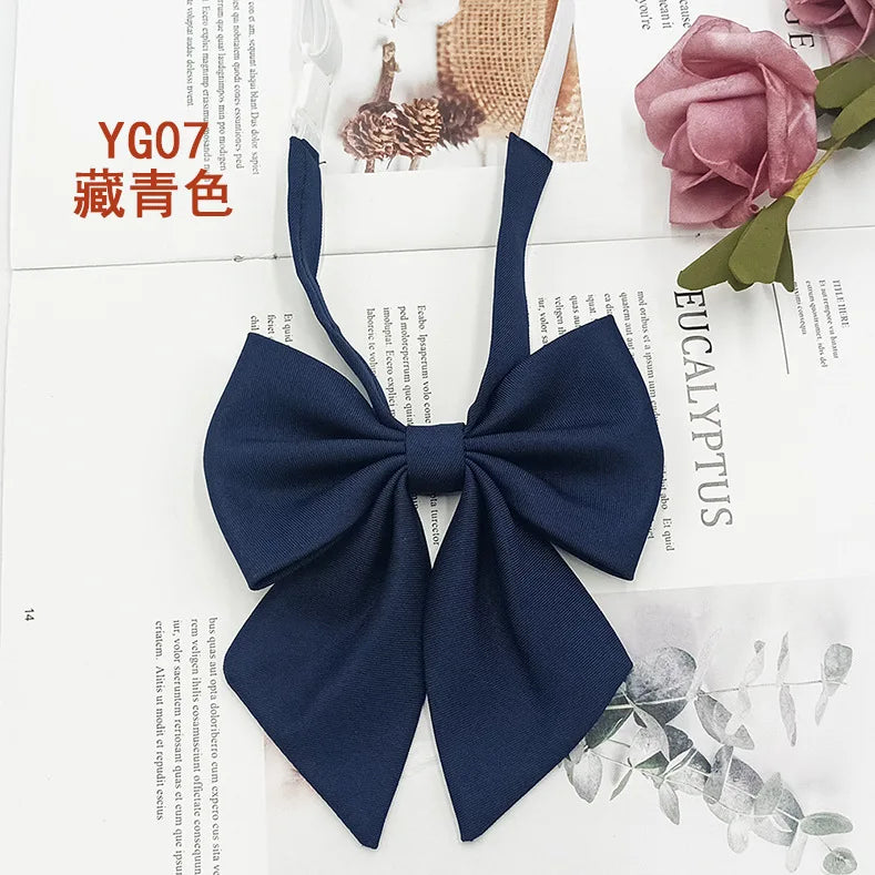 A dark navy blue solid cotton bow tie shown against a white background.