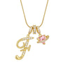 Gold letter T pendant necklace with small diamonds and a pink gemstone charm