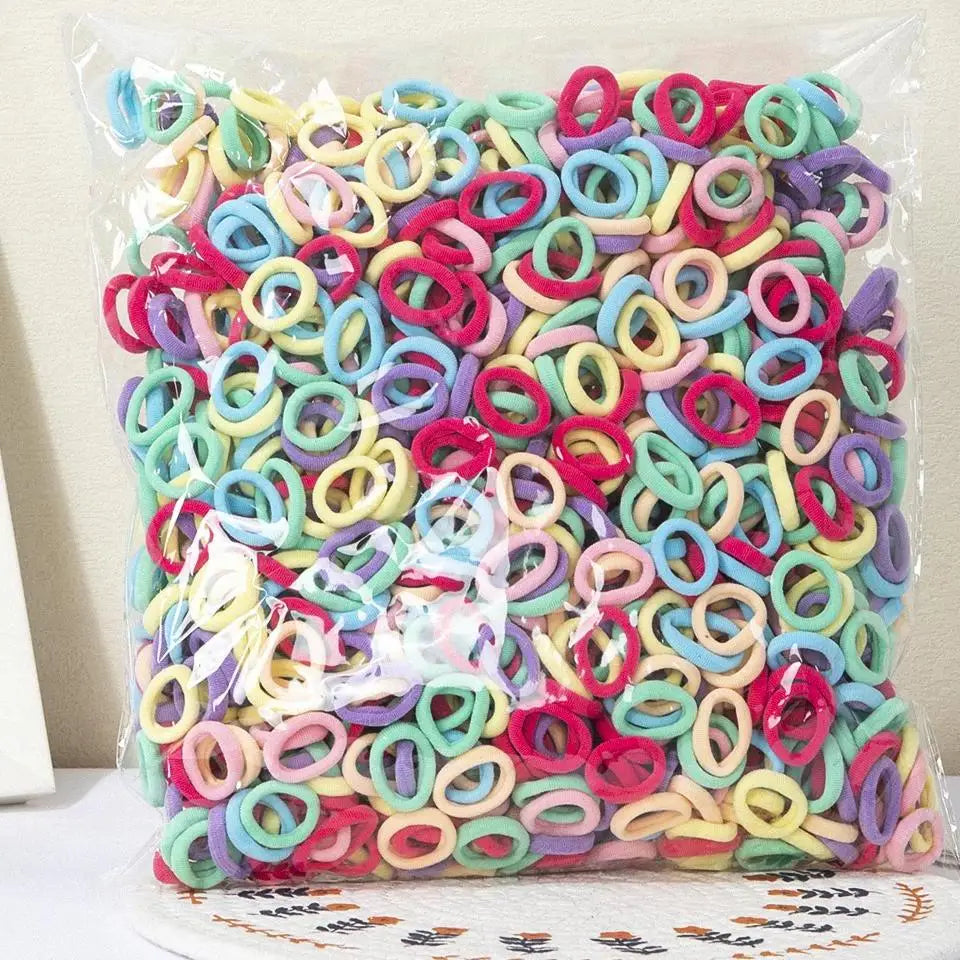 A clear plastic bag filled with colorful nylon elastic hair cords for kids headbands