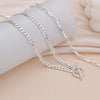Silver layered Cuban link necklace displayed on a light background.