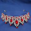 An elegant crystal rhinestone tiara and headband set featuring red and clear stones against a blue background.