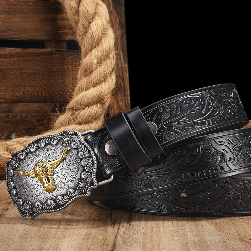 A black vintage western PU leather belt with an ornate silver buckle resting on a wooden surface.