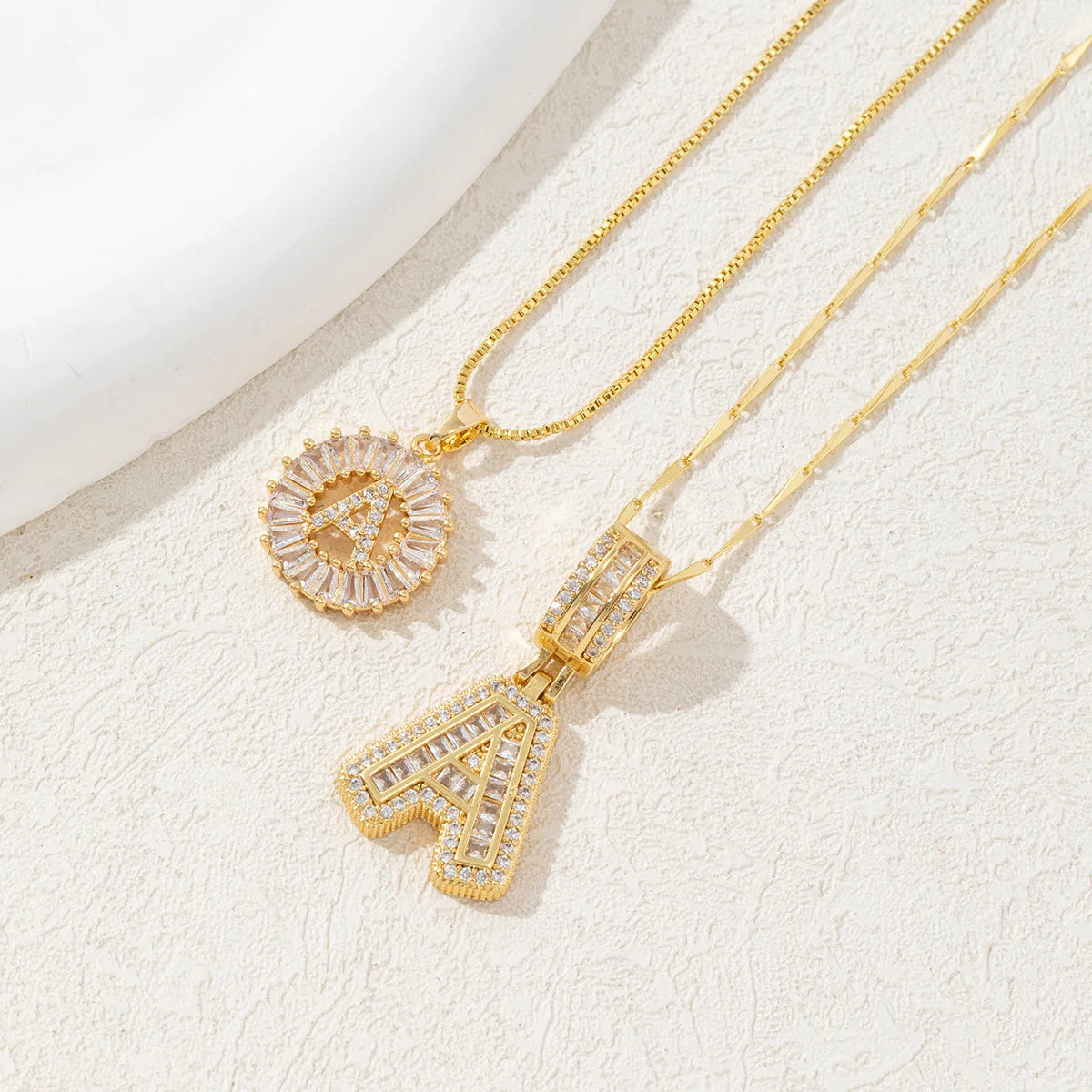 Gold-toned necklace set featuring crystal pendants shaped like the letters A and Z.