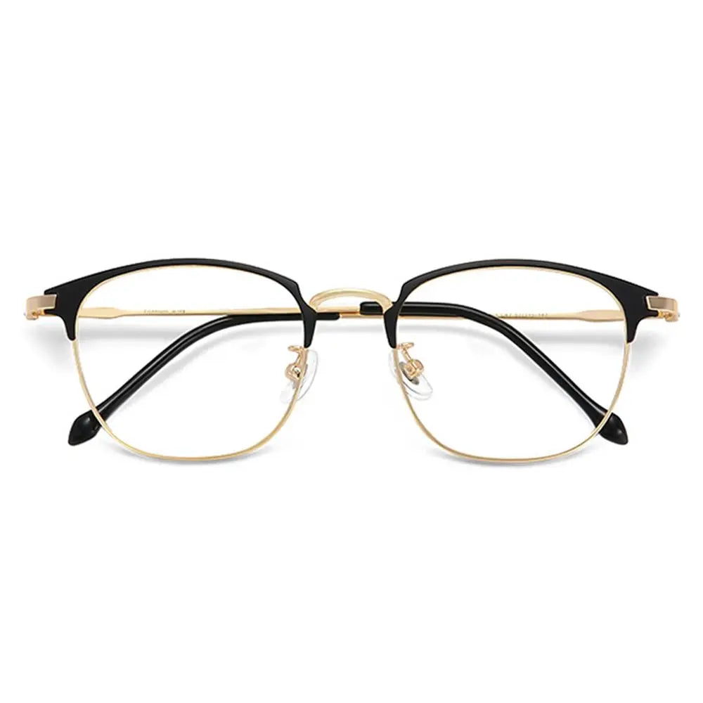 A pair of thin, gold-rimmed eyeglasses with black frames and clear lenses.