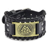 Black leather bracelet with a brass compass design and woven texture.