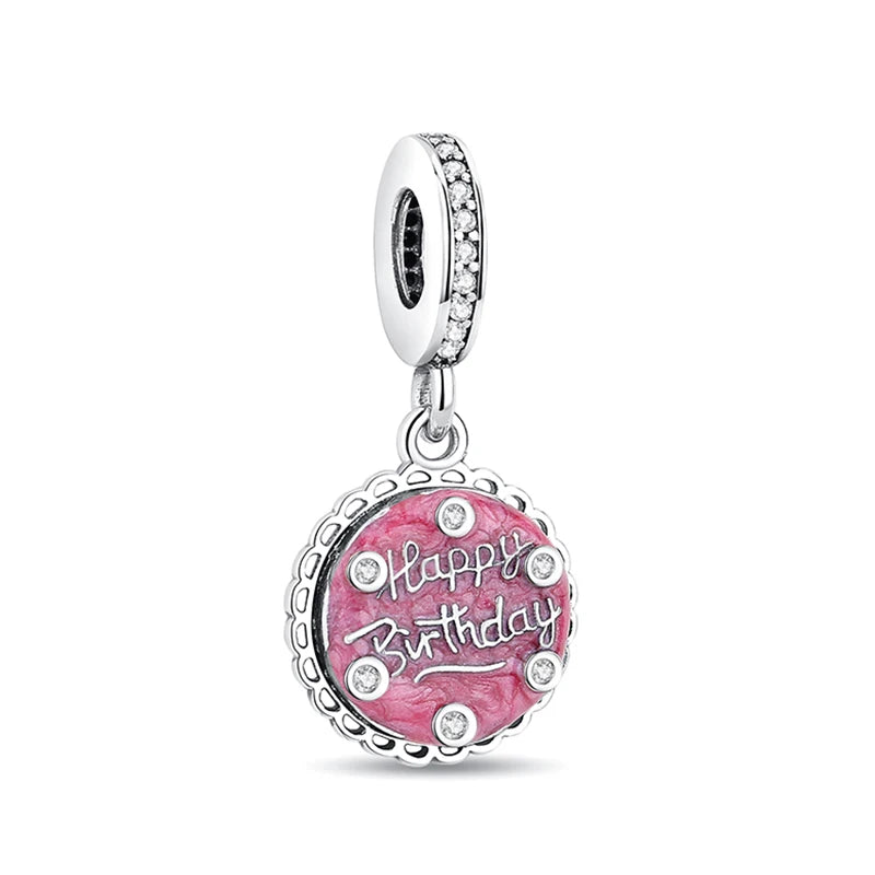 A silver family tree charm necklace with a round pink gemstone engraved with Happy Birthday