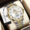A silver and gold quartz wristwatch with a metal bracelet is displayed on a light-colored box.