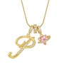 Gold letter pendant necklace featuring a diamond-encrusted initial and a pink gemstone charm